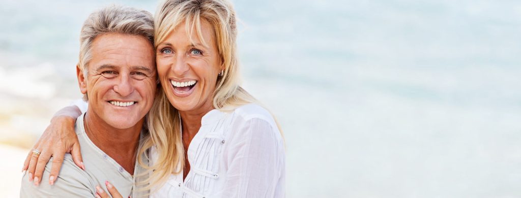 older man and woman close to each other and smiling