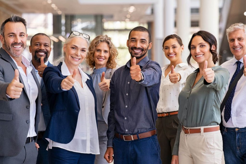 office personnel smiling and giving a thumbs up